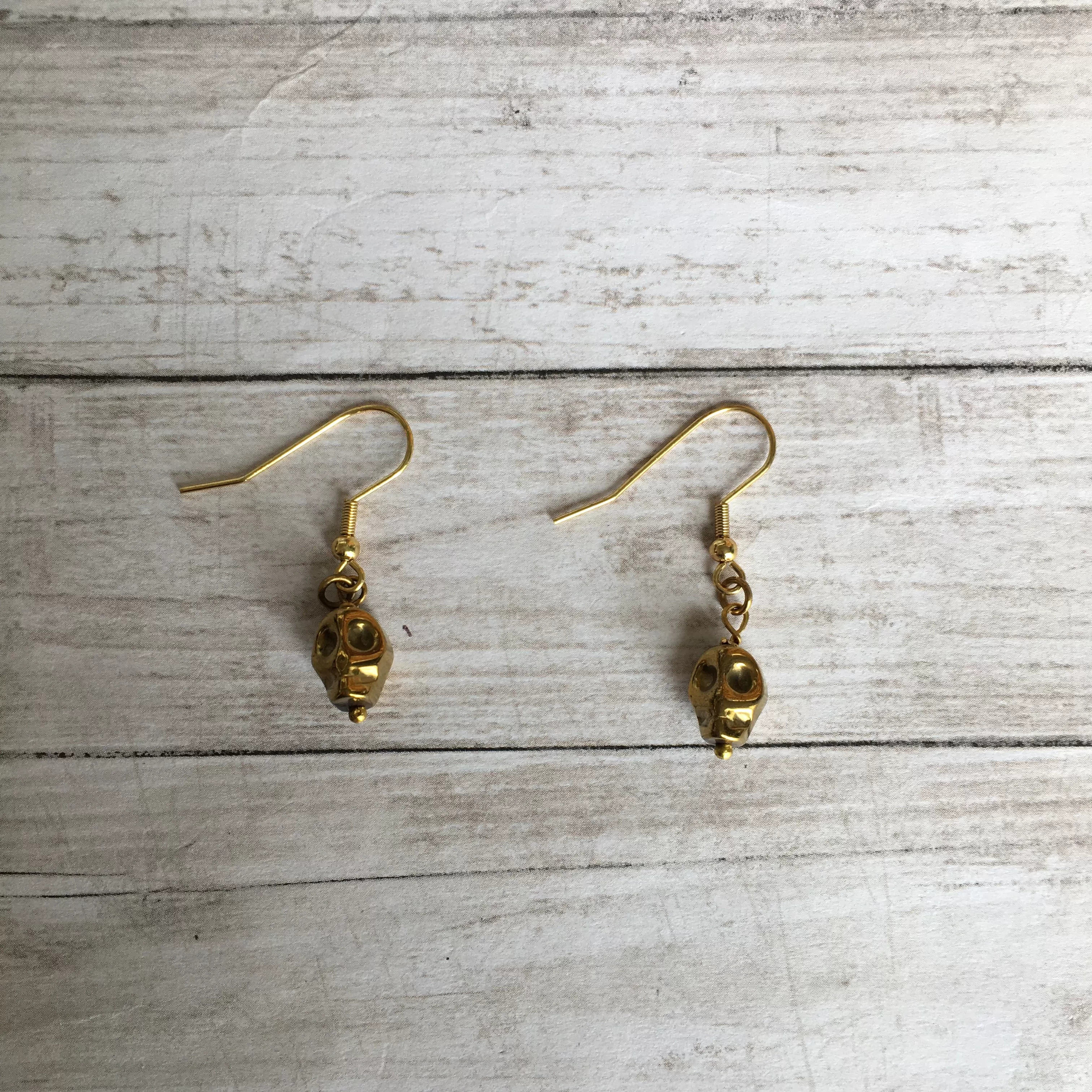 The Golden Hematite Skull Earrings